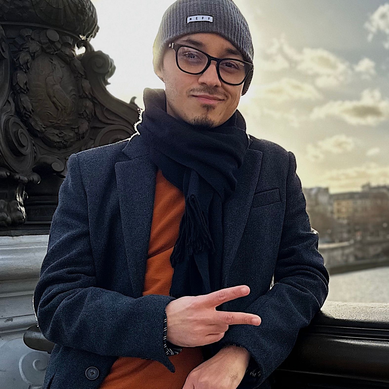 Portrait of PUCHO in a dark coat and scarf, in Paris