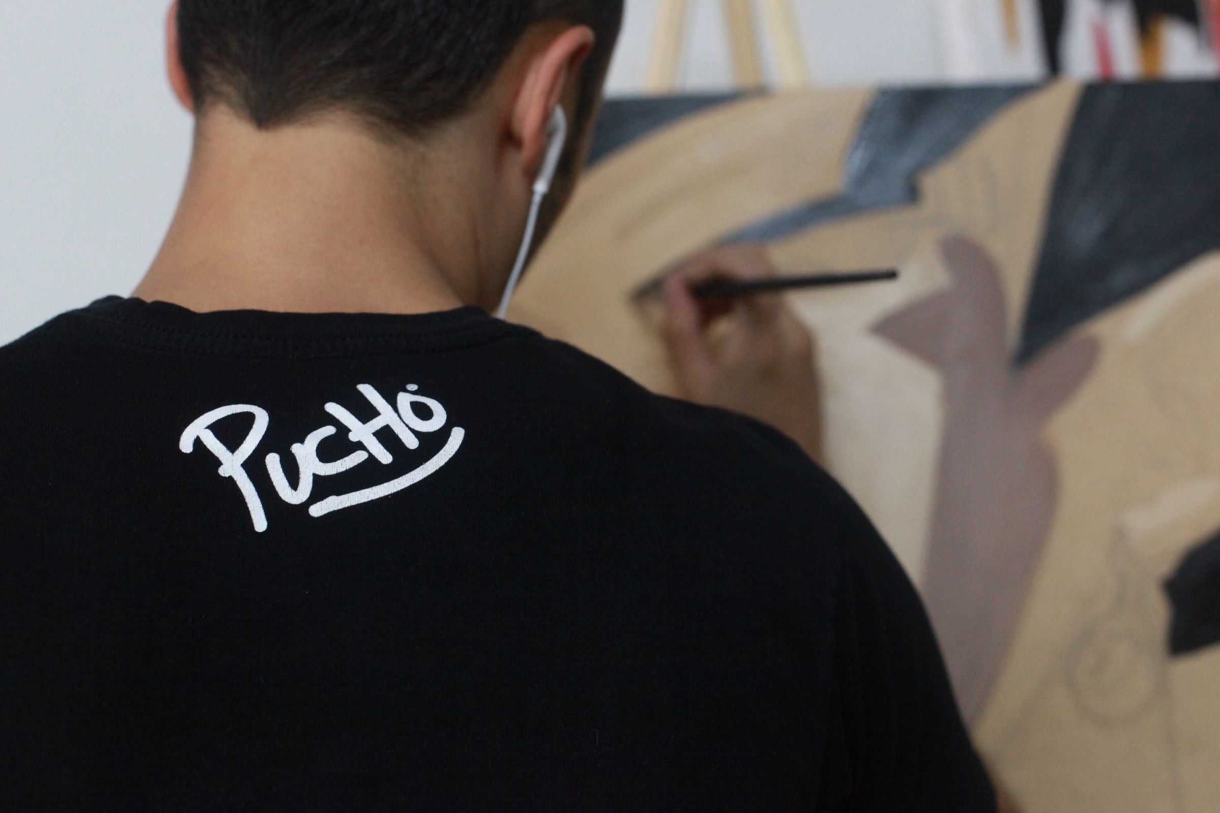 The artist painting geometric shapes in neutral tones
