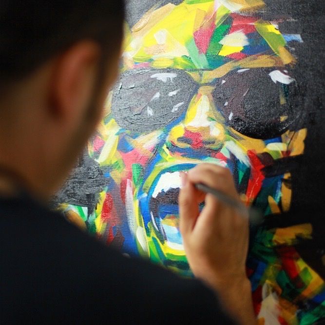The artist painting a portrait made of vivid multicolor brushstrokes